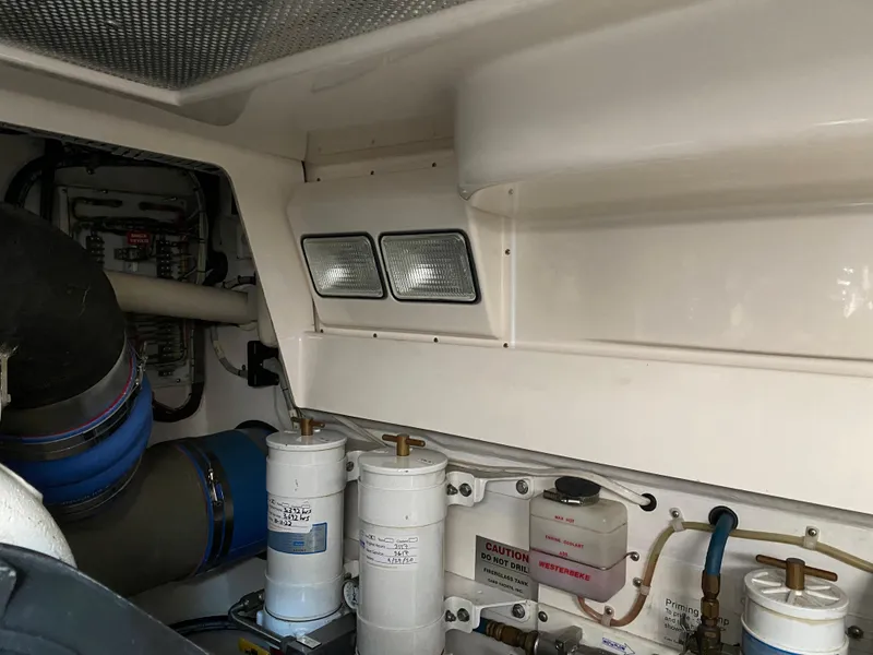 Slide: The Image of Engine room of 2005 Cabo 40 Hardtop Express with filters and ventilation system. - 46