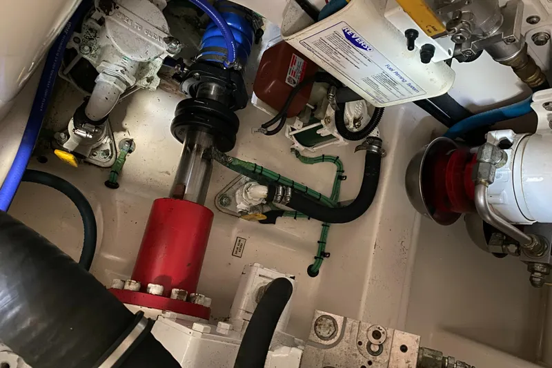 Slide: The Image of Engine compartment of a 2005 Cabo 40 Hardtop Express boat, showcasing mechanical components. - 47