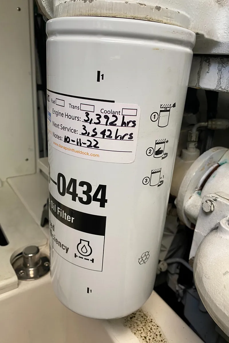 Slide: The Image of Oil filter with service details on a 2005 Cabo 40 Hardtop Express boat. - 48