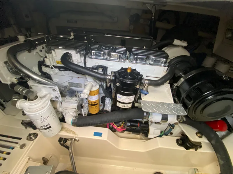 Slide: The Image of Engine compartment of a 2005 Cabo 40 Hardtop Express boat, showcasing detailed components. - 49