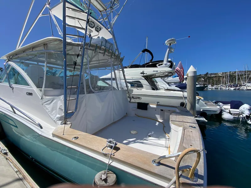 Slide: The Image of 2005 Cabo 40 Hardtop Express docked at a marina under clear blue skies. - 5