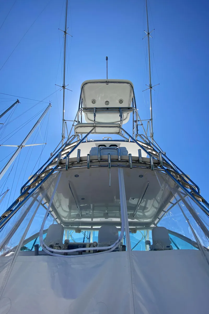 Slide: The Image of 2005 Cabo 40 Hardtop Express yacht against clear blue sky. - 9