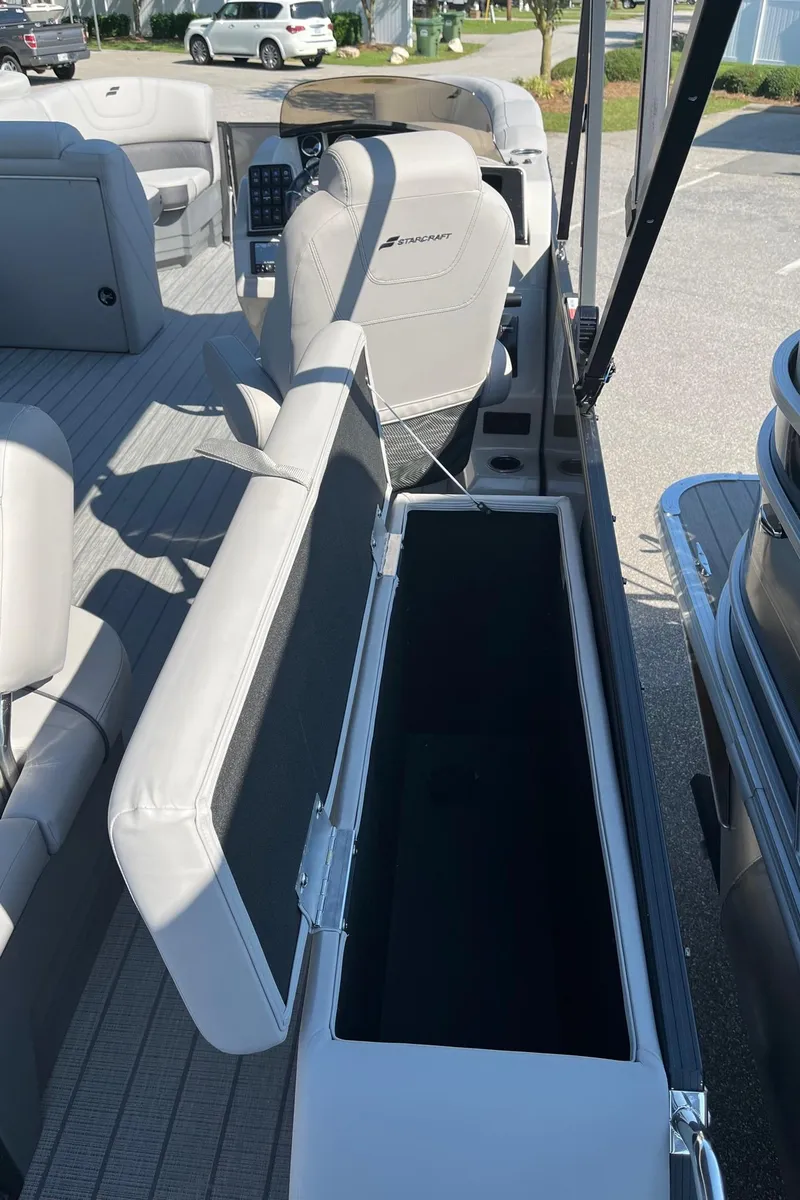 Slide: The Image of 2024 Starcraft SLS 3 Q DH pontoon boat interior with open storage compartment. - 12