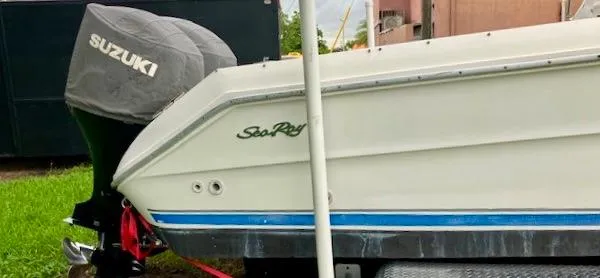 Slide: The Image of Sea Ray 240 Sundeck 1990 boat with Suzuki outboard motor. - 14