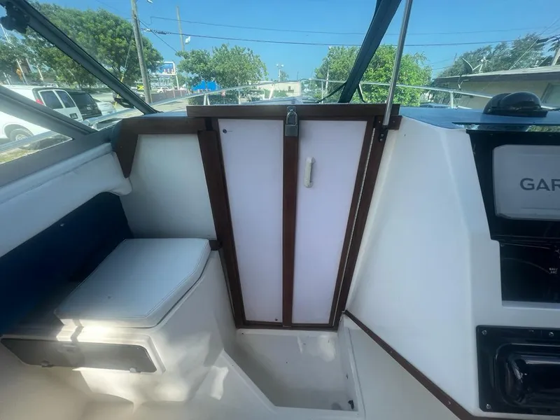 Slide: The Image of Interior of 1990 Sea Ray 240 Sundeck boat with seating and control panel. - 28