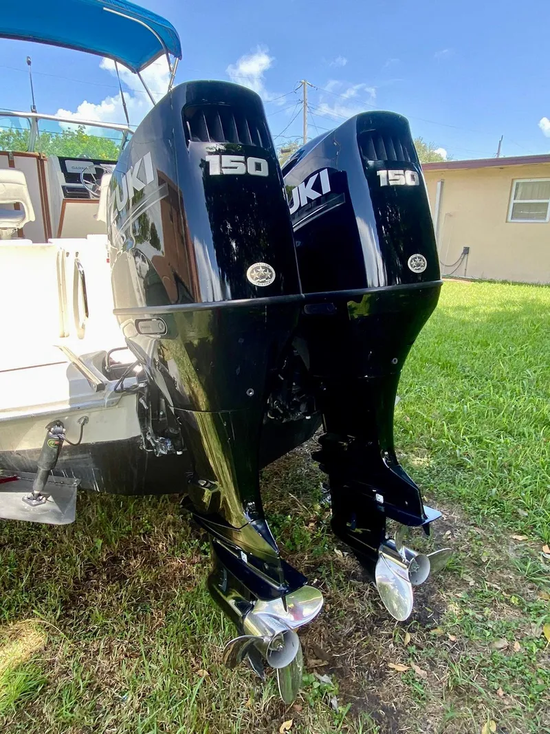 Slide: The Image of Twin Suzuki 150 outboard motors on a 1990 Sea Ray 240 Sundeck boat. - 8