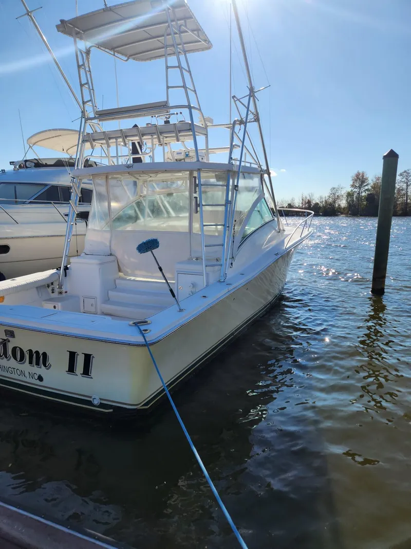 Slide: The Image of 2004 Luhrs 36 Open boat docked in a marina on a sunny day. - 10