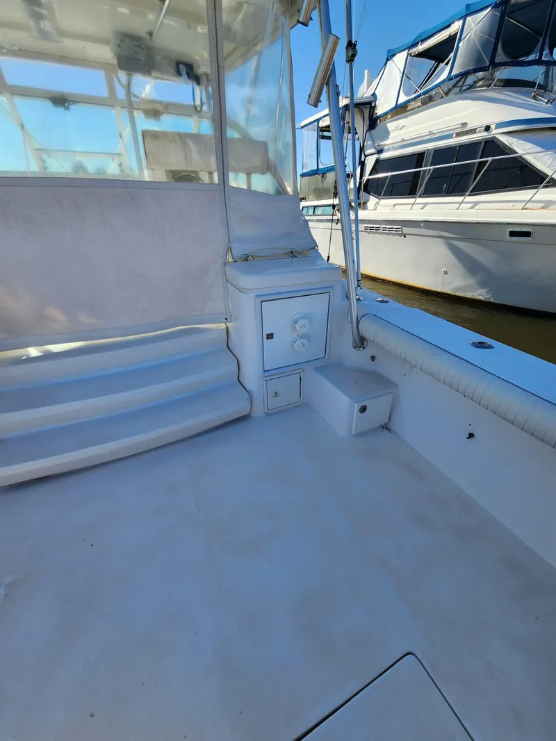 Slide: The Image of 2004 Luhrs 36 Open boat interior, featuring clean deck and seating area. - 16