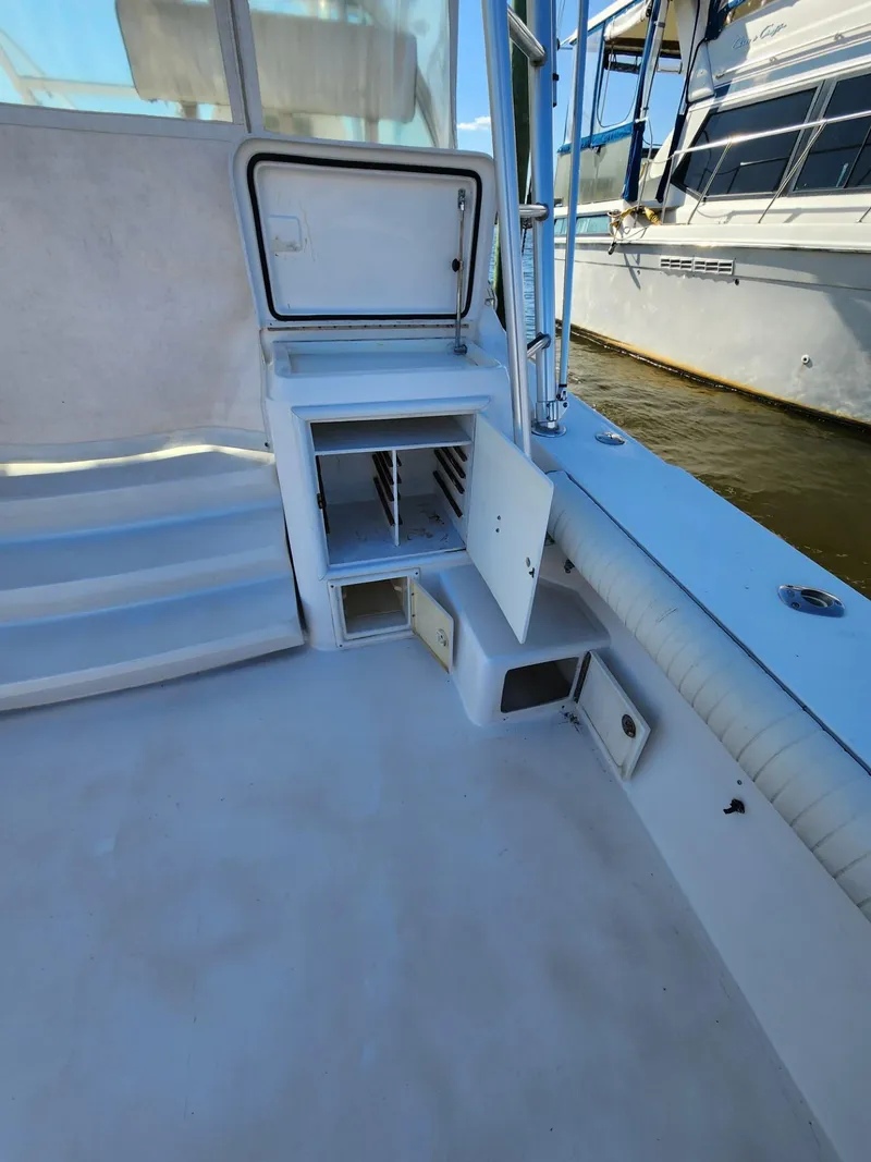 Slide: The Image of 2004 Luhrs 36 Open boat interior with storage compartments and steps. - 17