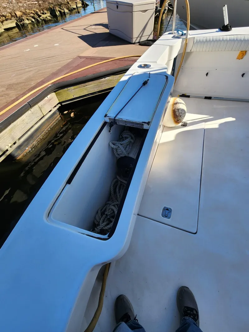 Slide: The Image of 2004 Luhrs 36 Open boat deck with storage compartment and dock view. - 19