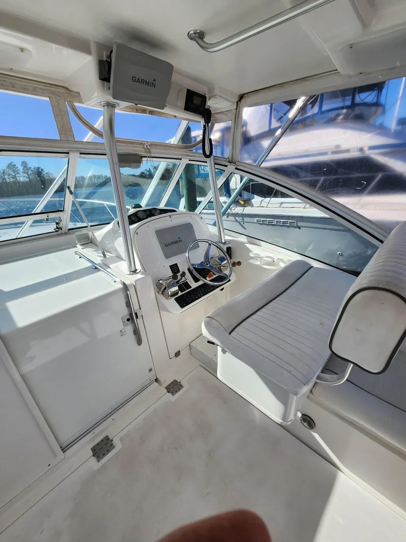 Slide: The Image of 2004 Luhrs 36 Open boat interior with helm station and seating. - 22
