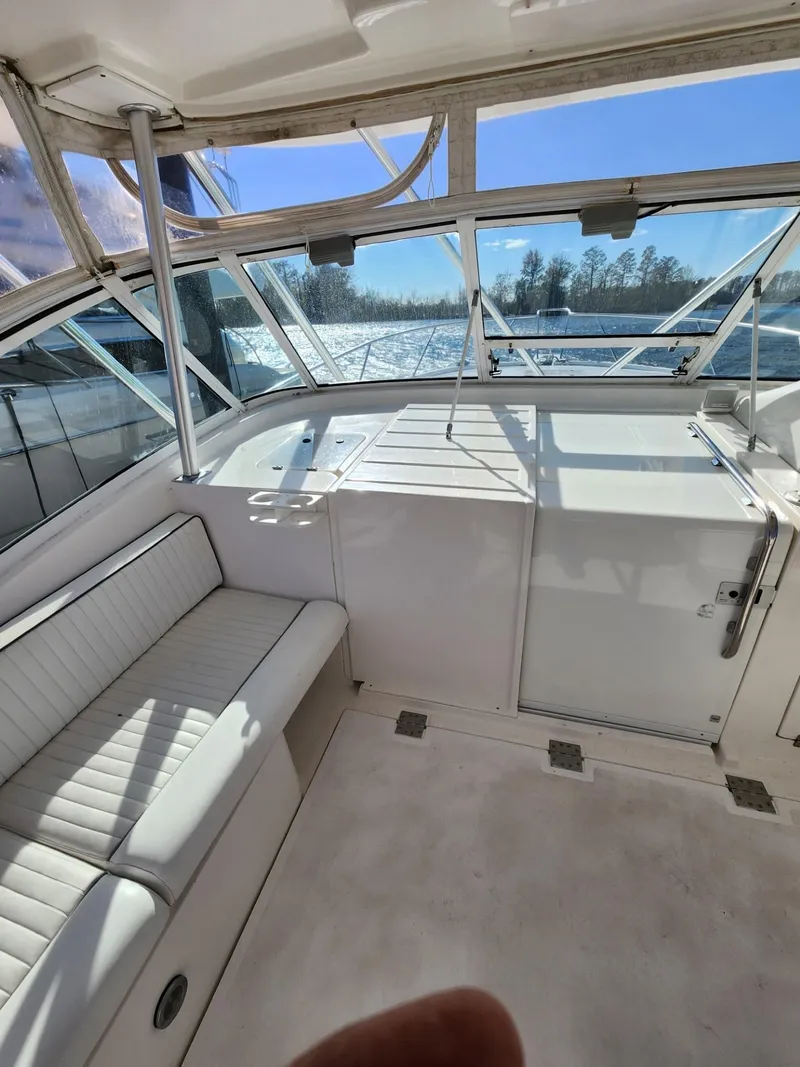 Slide: The Image of 2004 Luhrs 36 Open boat interior with white seating and large windows. - 27