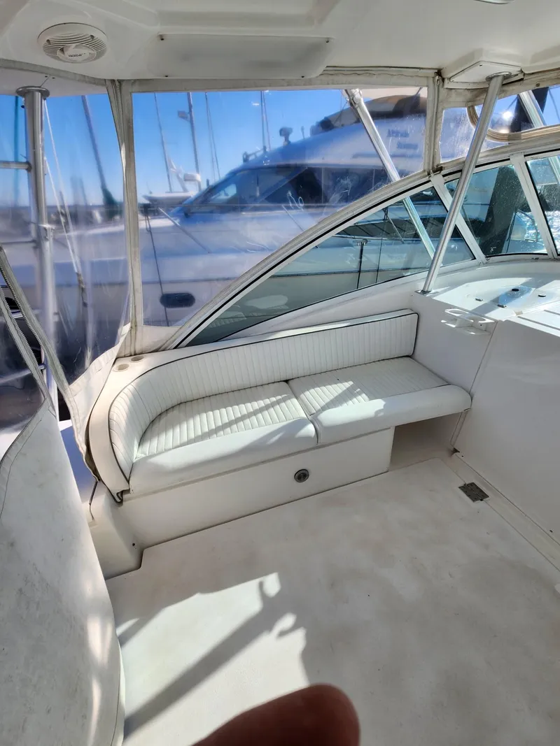 Slide: The Image of 2004 Luhrs 36 Open boat interior with white seating and windows. - 28