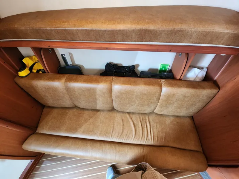 Slide: The Image of 2004 Luhrs 36 Open cabin interior with tan leather seating and storage compartments. - 33