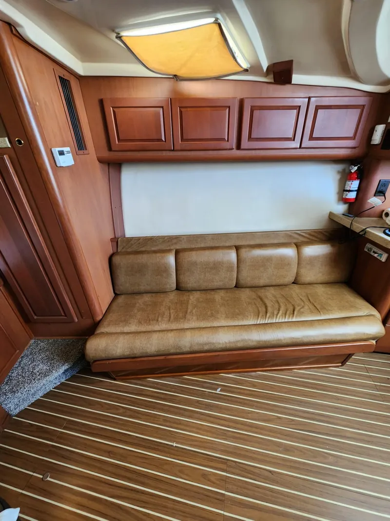 Slide: The Image of 2004 Luhrs 36 Open interior with leather seating and wooden cabinetry. - 34