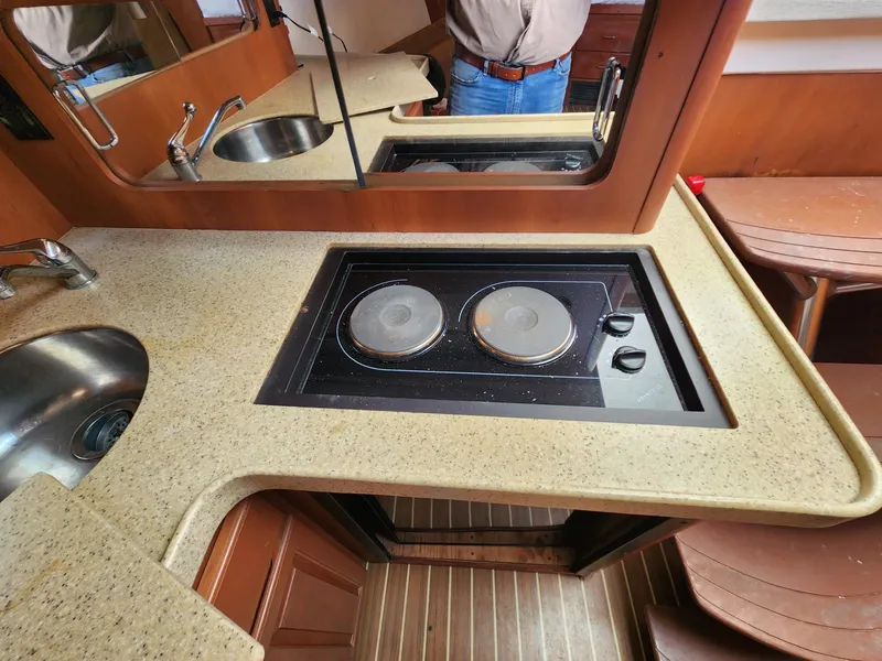 Slide: The Image of 2004 Luhrs 36 Open yacht kitchen with stove and sink. - 38