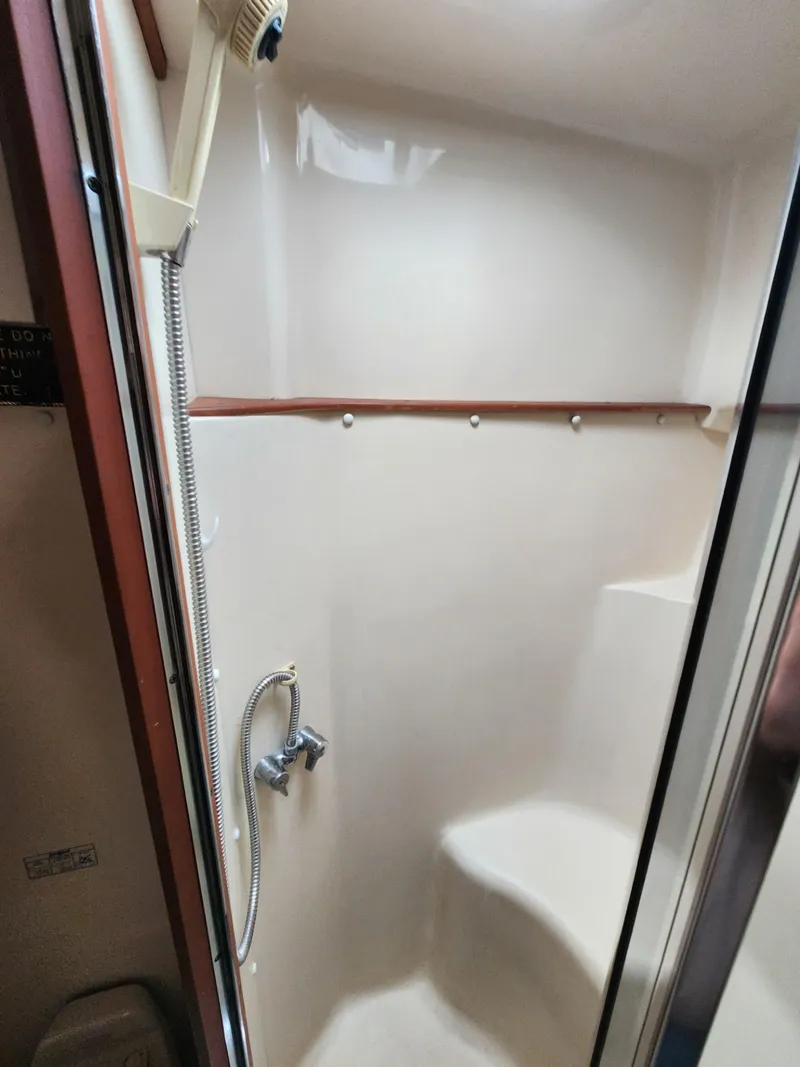 Slide: The Image of 2004 Luhrs 36 Open boat shower with handheld showerhead and seating. - 44