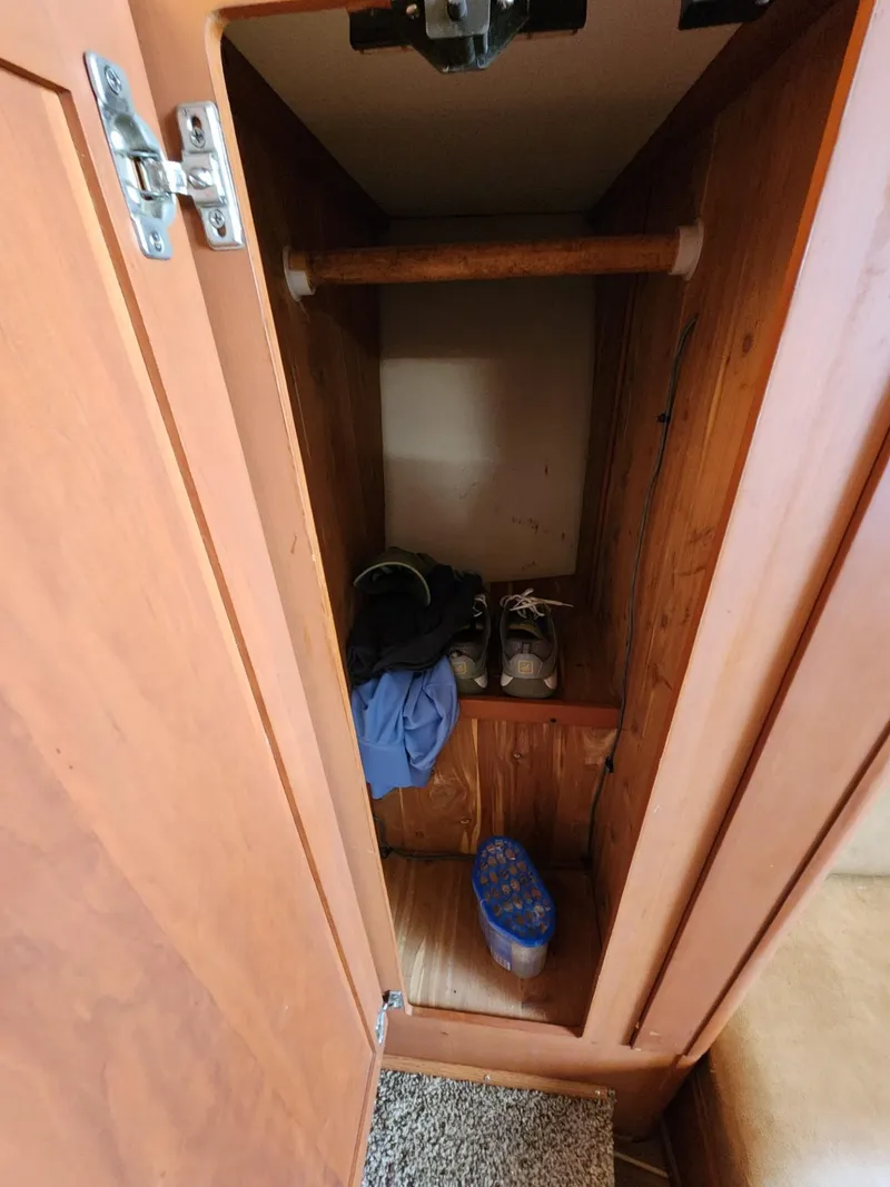 Slide: The Image of Open closet in 2004 Luhrs 36 Open boat with clothes and shoes. - 47
