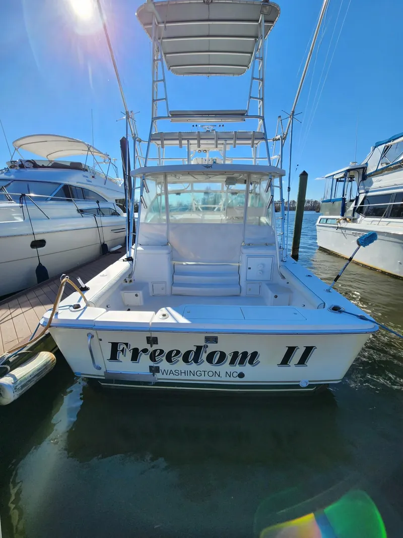 Slide: The Image of 2004 Luhrs 36 Open boat named Freedom II docked in a marina. - 5