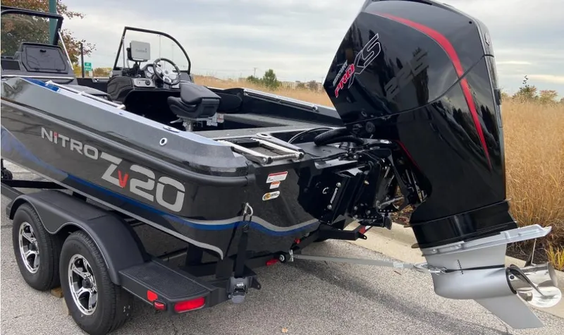 Slide: The Image of 2024 Nitro ZV20 boat with powerful outboard motor on trailer. - 2