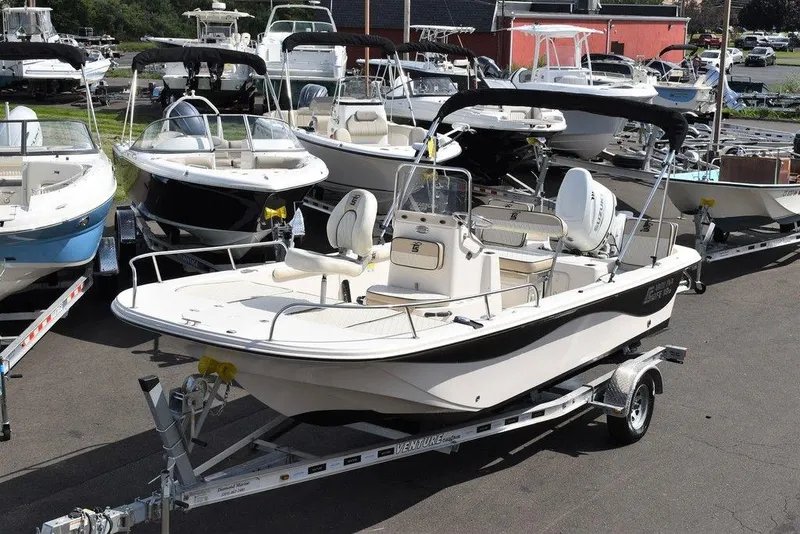 Slide: The Image of 2021 Carolina Skiff 19 LS boat on trailer, surrounded by other boats. - 1