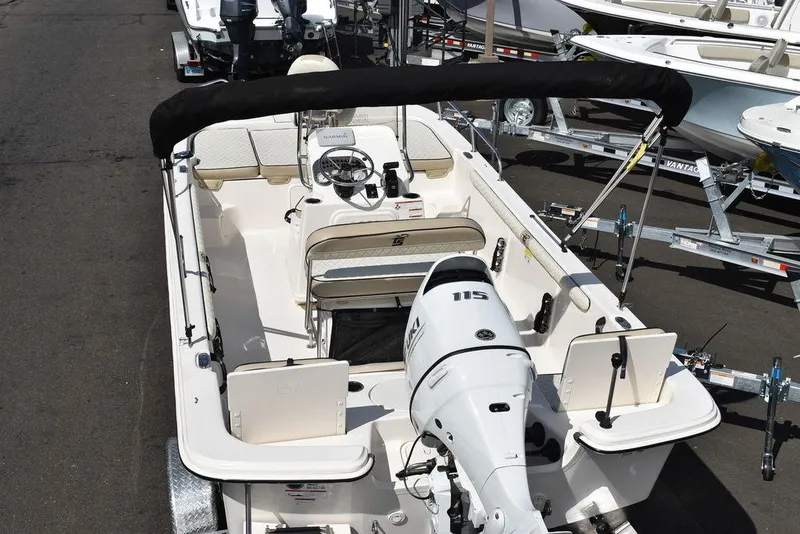 Slide: The Image of 2021 Carolina Skiff 19 LS boat with outboard motor and seating, docked on trailer. - 10