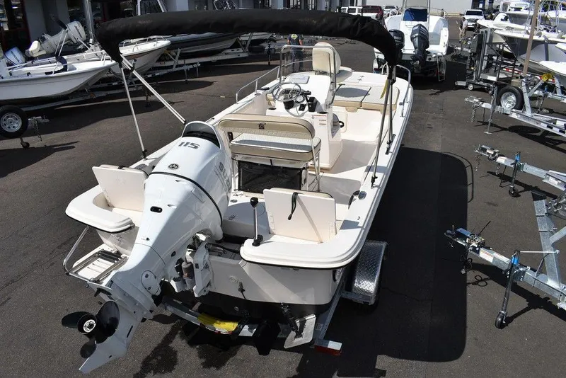 Slide: The Image of 2021 Carolina Skiff 19 LS boat with outboard motor, parked on a trailer. - 11