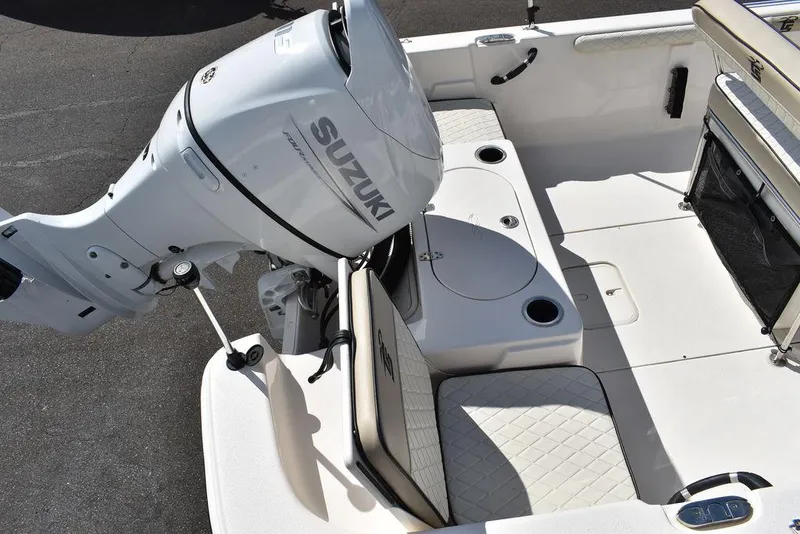 Slide: The Image of 2021 Carolina Skiff 19 LS boat with Suzuki outboard motor, featuring spacious seating and storage. - 12