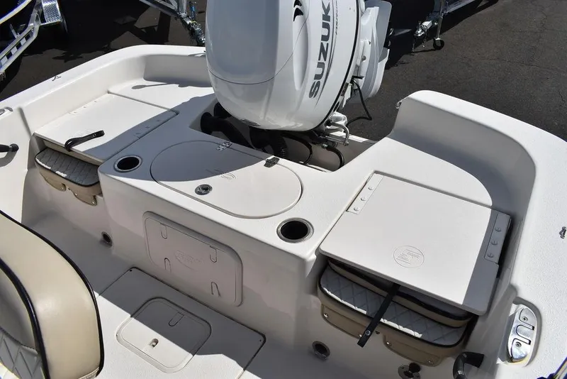 Slide: The Image of 2021 Carolina Skiff 19 LS boat with Suzuki outboard motor, featuring storage compartments. - 23