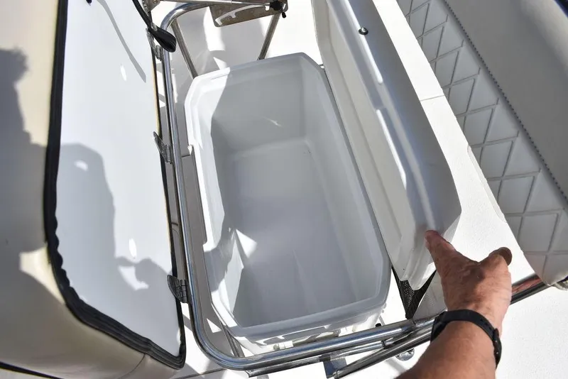 Slide: The Image of 2021 Carolina Skiff 19 LS boat cooler compartment with open lid. - 31