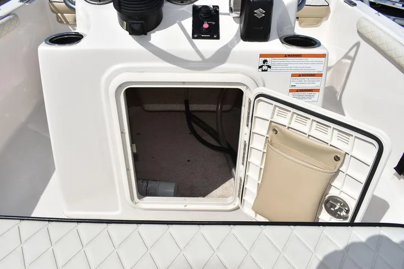 Slide: The Image of 2021 Carolina Skiff 19 LS boat console storage compartment with open hatch. - 37