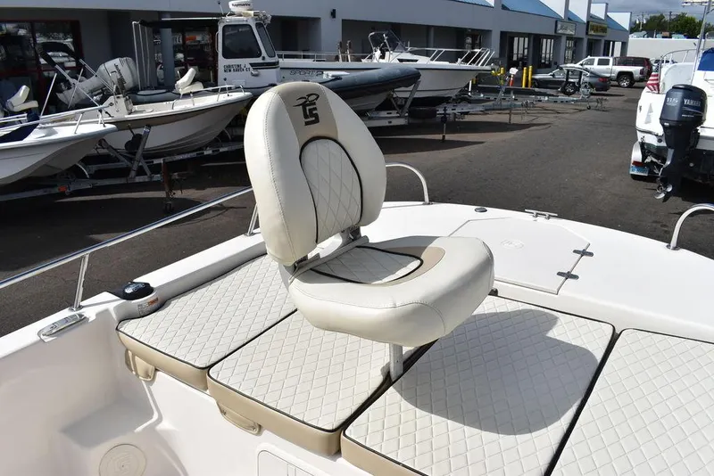 Slide: The Image of 2021 Carolina Skiff 19 LS boat seat with quilted upholstery in a marina setting. - 42