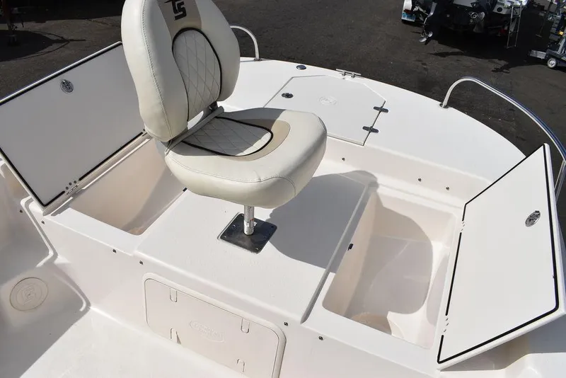 Slide: The Image of 2021 Carolina Skiff 19 LS boat interior with storage compartments and cushioned seat. - 43