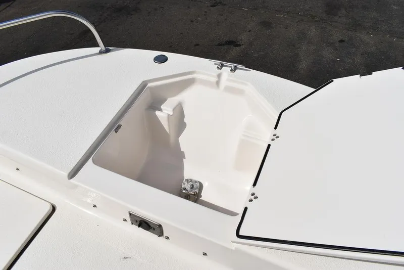 Slide: The Image of 2021 Carolina Skiff 19 LS boat storage compartment, open lid, white interior. - 46