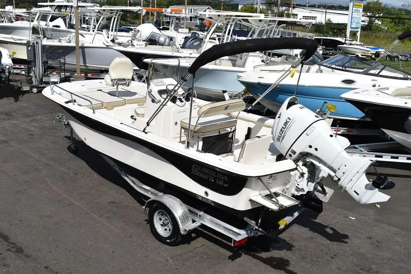 Slide: The Image of 2021 Carolina Skiff 19 LS boat on trailer in marina setting. - 6