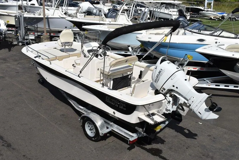 Slide: The Image of 2021 Carolina Skiff 19 LS boat on trailer, parked among other boats. - 7