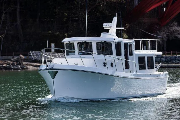 Slide: The Image of 2025 American Tug 362 cruising on a calm river. - 13