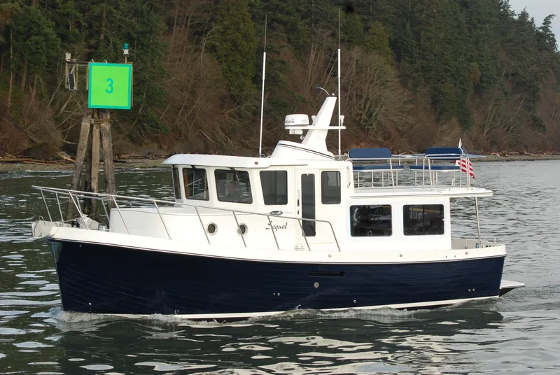 Slide: The Image of 2025 American Tug 362 cruising near a green channel marker. - 17