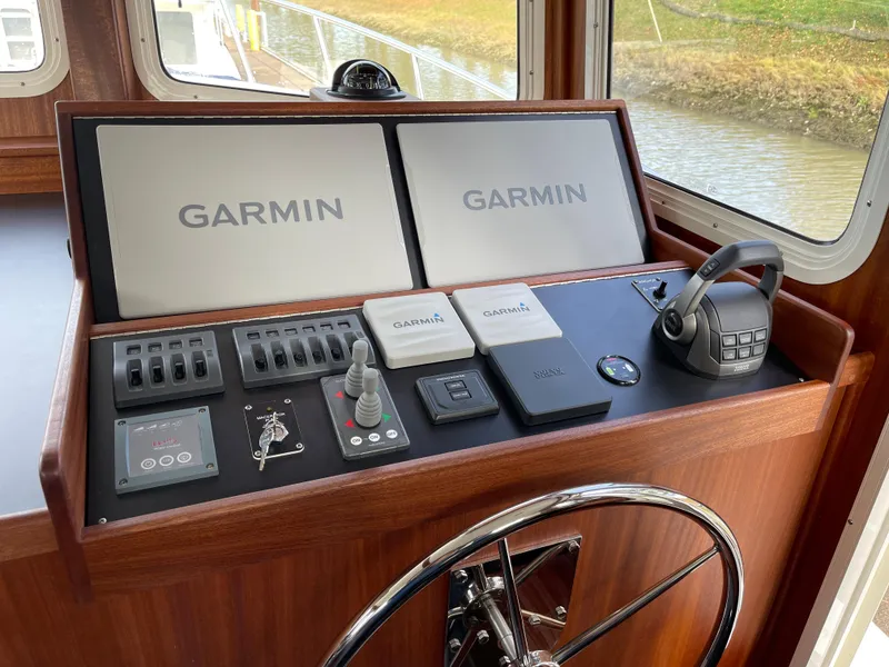 Slide: The Image of American Tug 362 2025 helm with dual Garmin displays and navigation controls. - 26