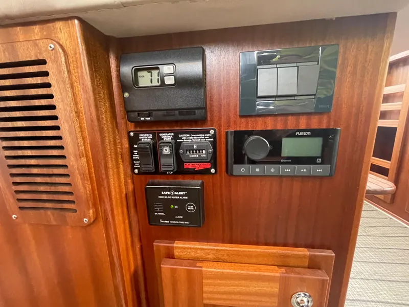 Slide: The Image of Control panel of a 2025 American Tug 362 with various switches and gauges. - 30