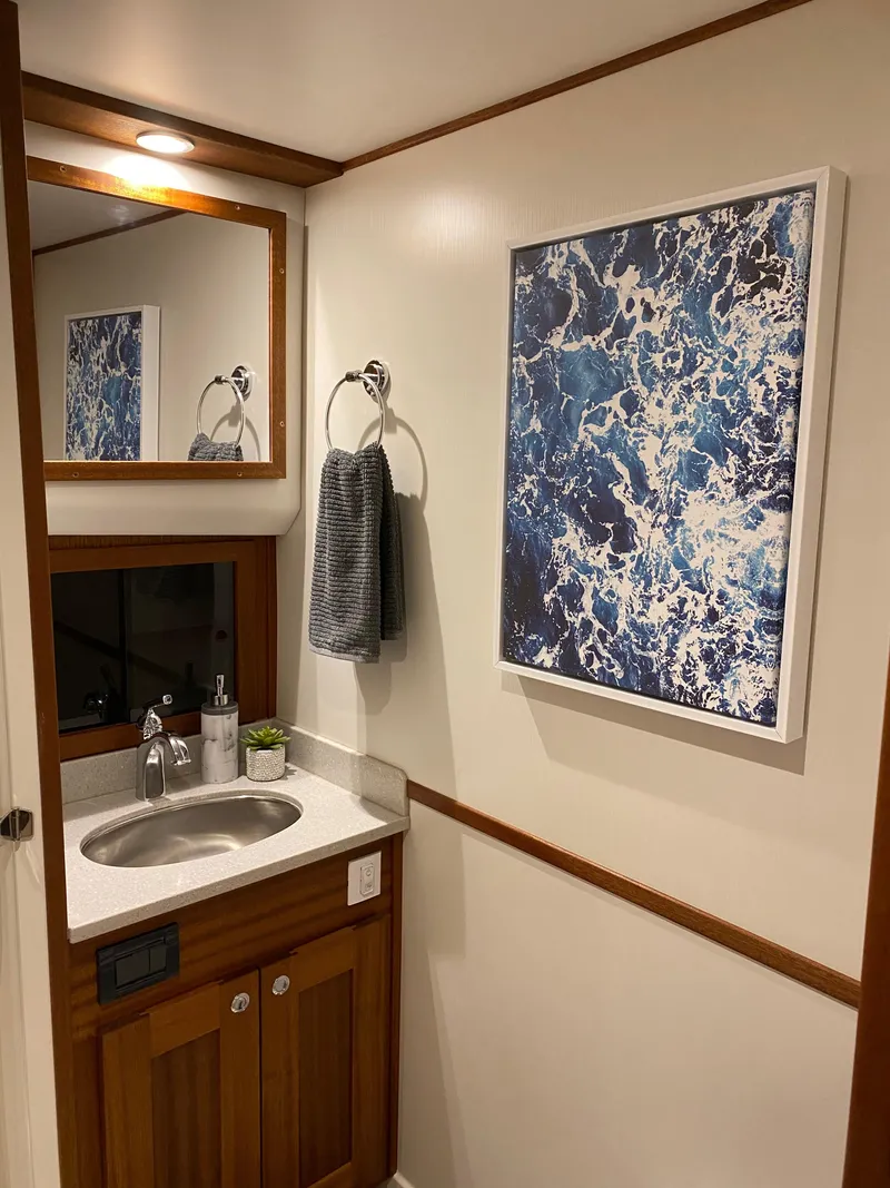 Slide: The Image of Modern bathroom in 2025 American Tug 362 with ocean-themed artwork. - 36