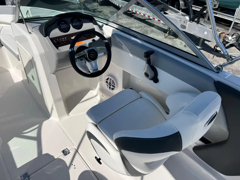 Slide: The Image of 2024 Chaparral 19 SSi boat cockpit with steering wheel and captain's chair. - 6