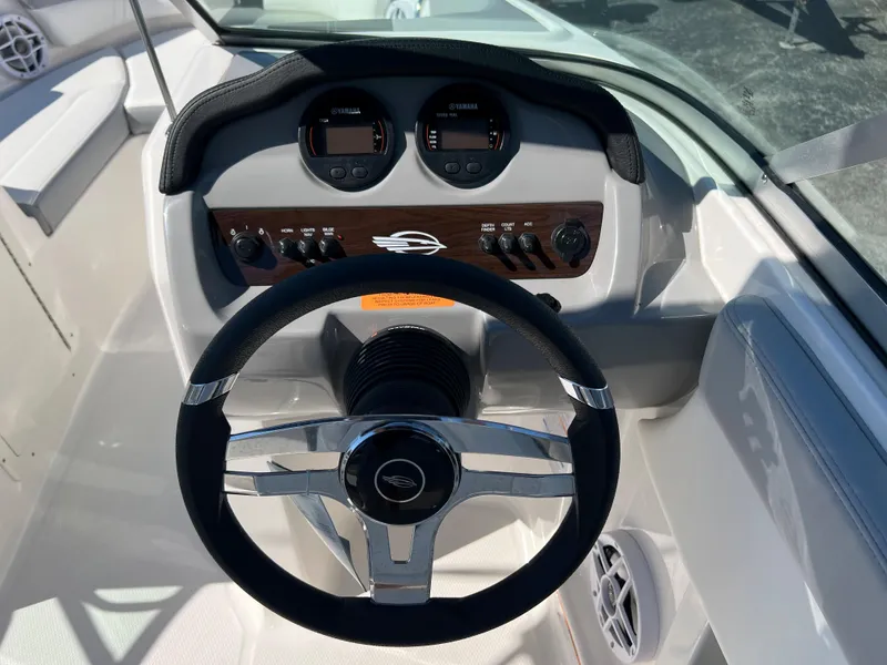 Slide: The Image of 2024 Chaparral 19 SSi boat dashboard with steering wheel and instrument panel. - 7