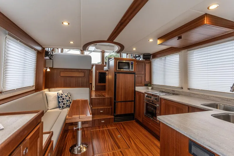 Slide: The Image of Luxurious interior of 2026 American Tug 395 with wood finishes and modern amenities. - 10