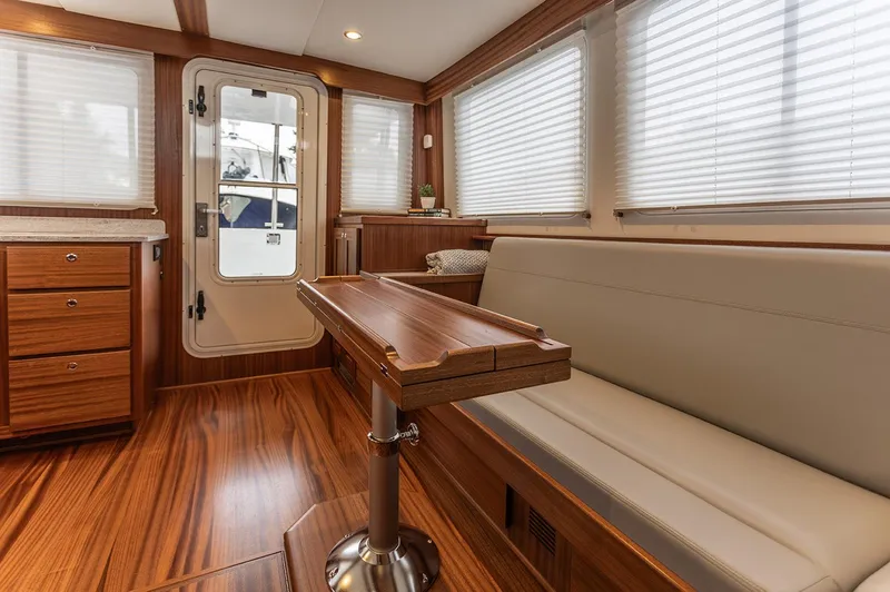 Slide: The Image of Interior of 2026 American Tug 395 with wood flooring and seating area. - 12