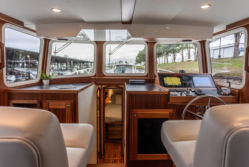 Slide: The Image of Interior of 2026 American Tug 395, featuring helm, seating, and navigation equipment. - 3