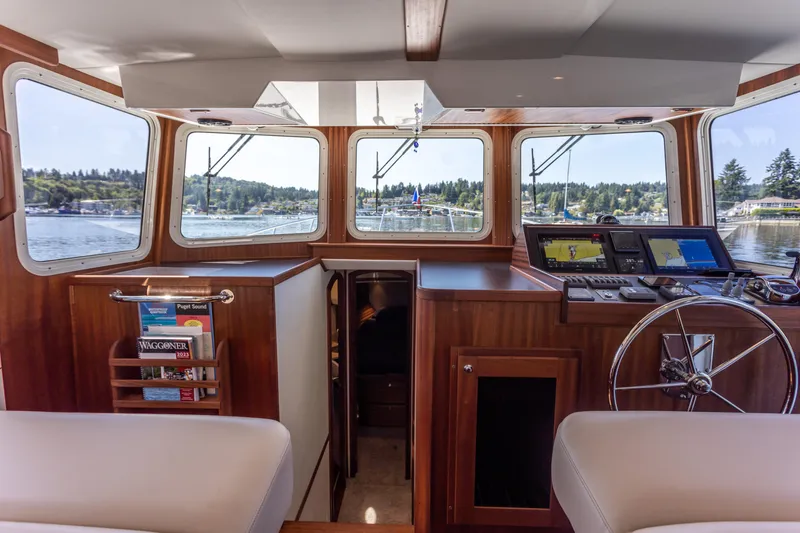 Slide: The Image of Interior view of 2026 American Tug 395, featuring helm and navigation equipment. - 4