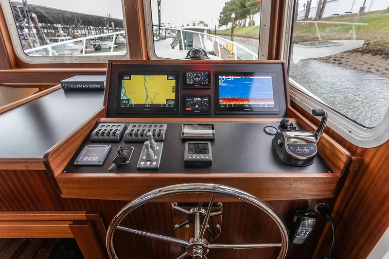Slide: The Image of American Tug 395 helm, 2026 model, featuring navigation screens and controls. - 5