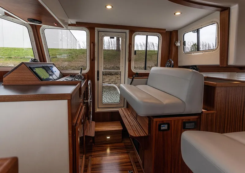 Slide: The Image of Interior of 2026 American Tug 395, featuring wood accents and modern seating. - 6