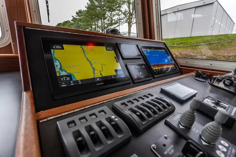 Slide: The Image of Control panel of 2026 American Tug 395 with navigation screens and controls. - 7